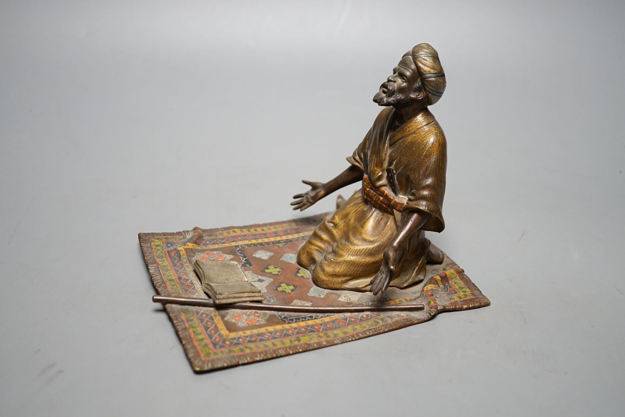 An enamelled, cold-painted bronze kneeling figure, unsigned, probably Franz Bergman, 16 cms deep x 13 cms high.